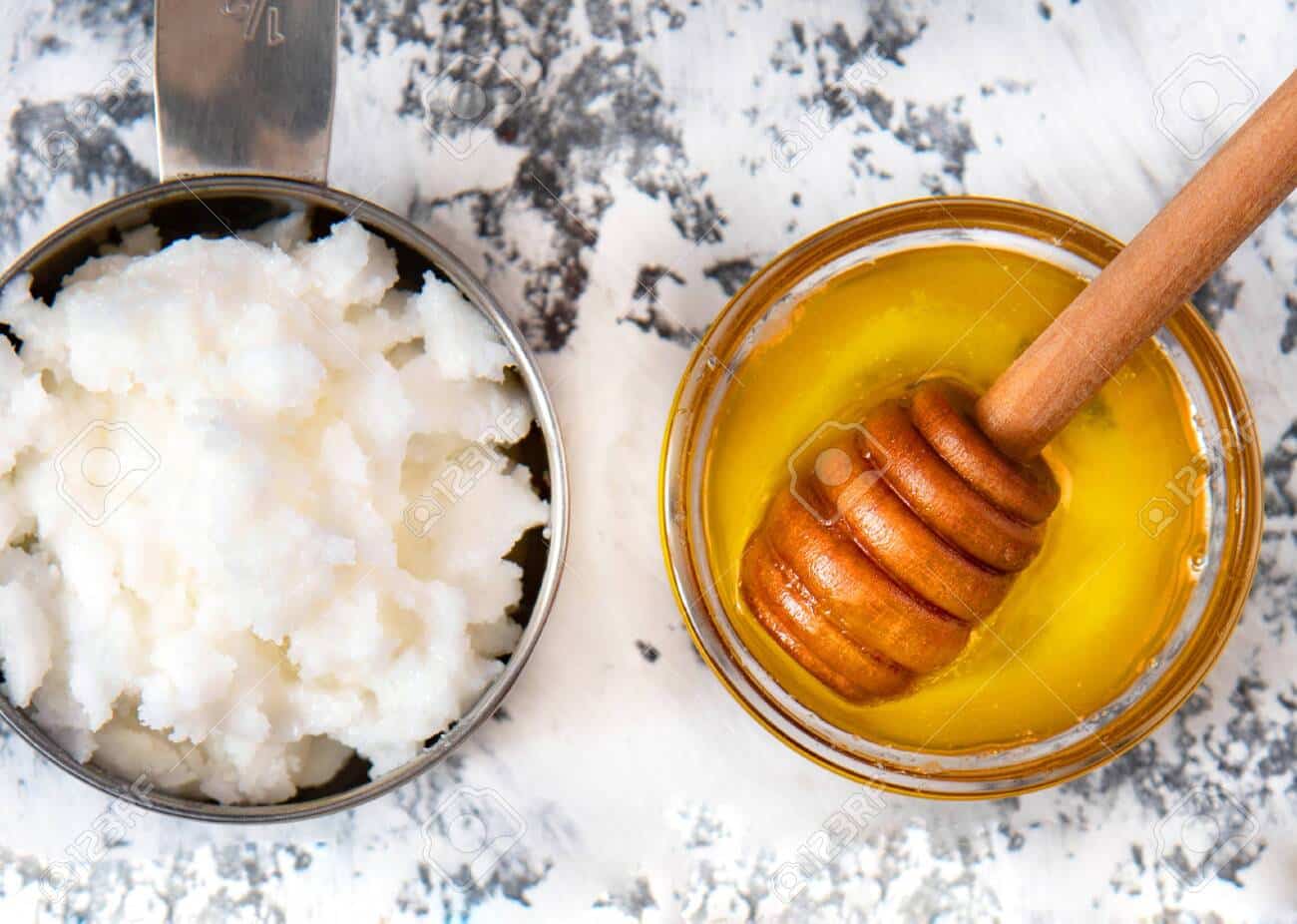150584091 homemade hair mask made out of coconut butter and honey white background