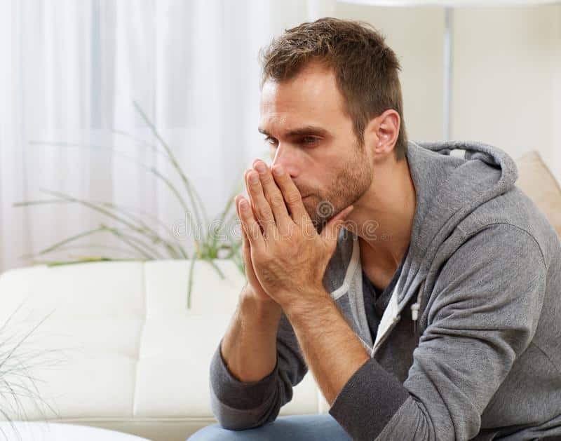 anxious man sad portrait over modern apartment background 81354223