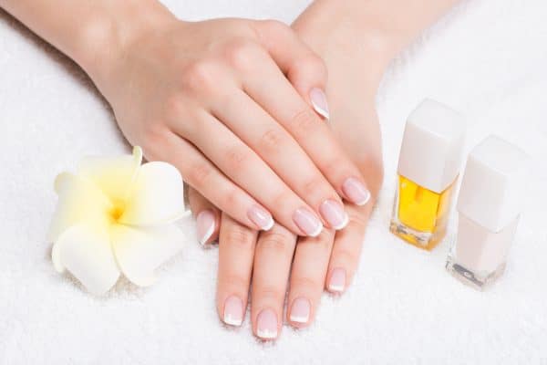 woman nail salon receiving manicure by beautician beauty treatment concept e1642938609184 1